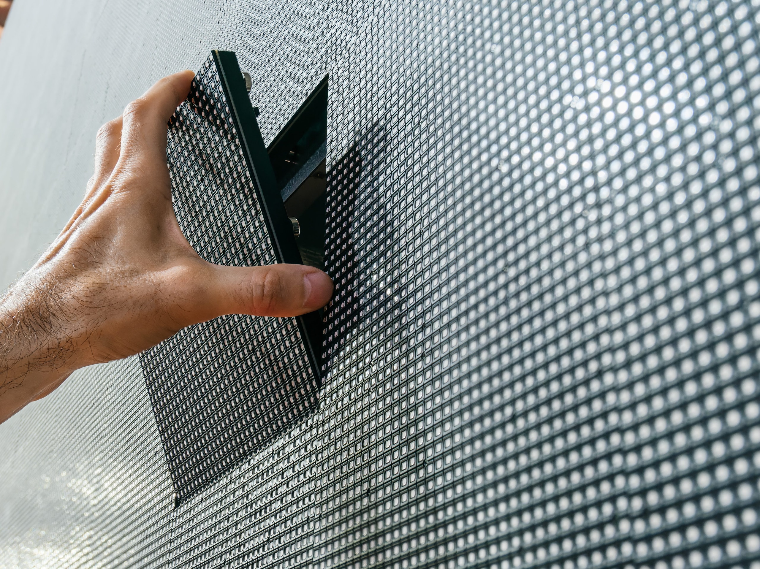 Technician removing a module from an LED video wall.